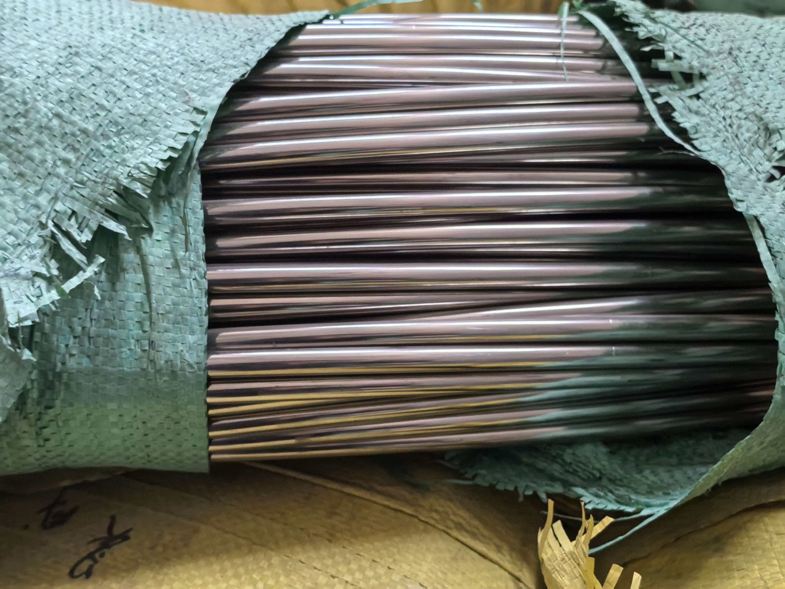 Stacks of coins next to coils of 201 and 304 steel wire