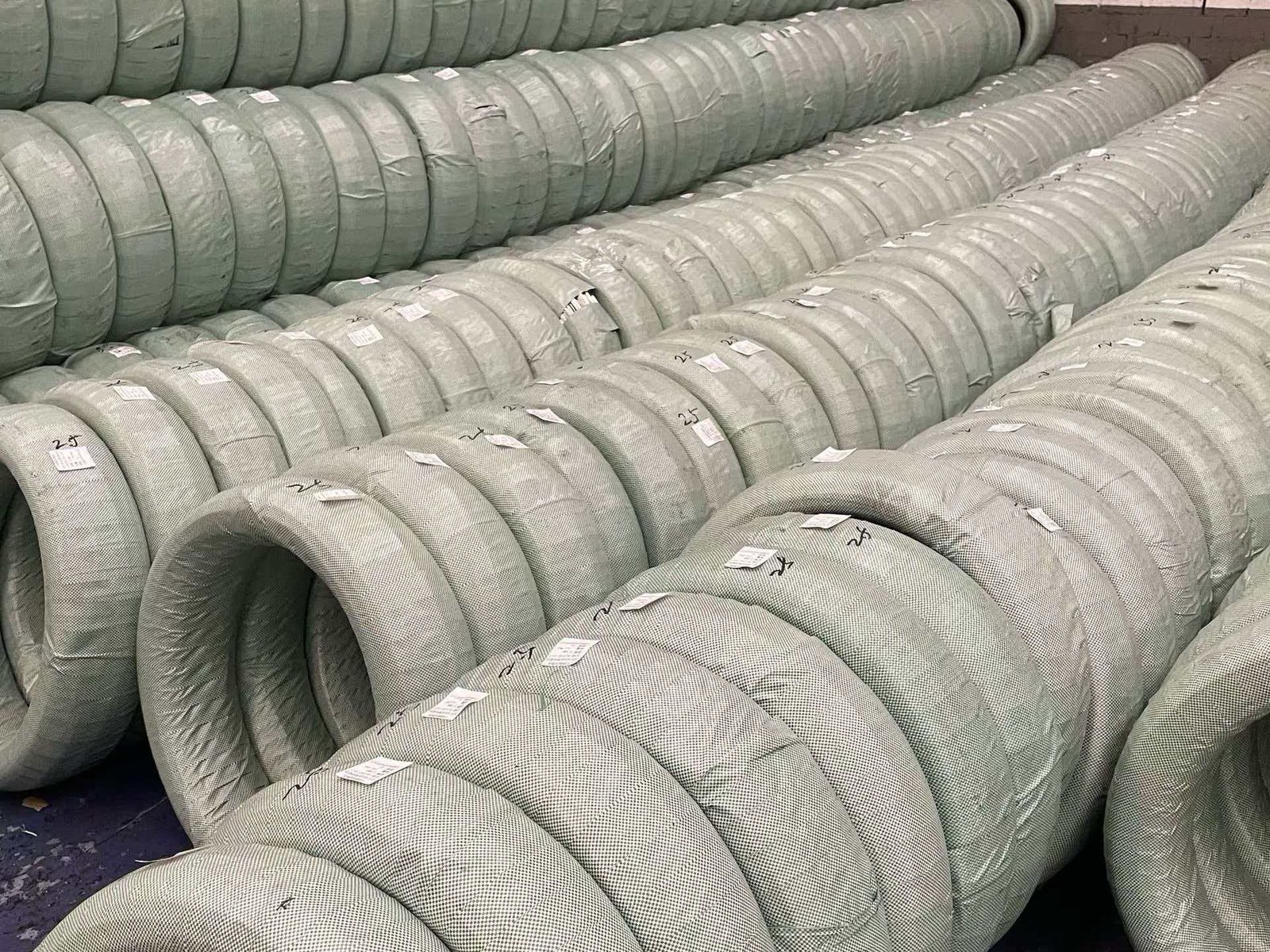 1.0mm Wire for Welded Mesh Production A roll of welded wire mesh being manufactured