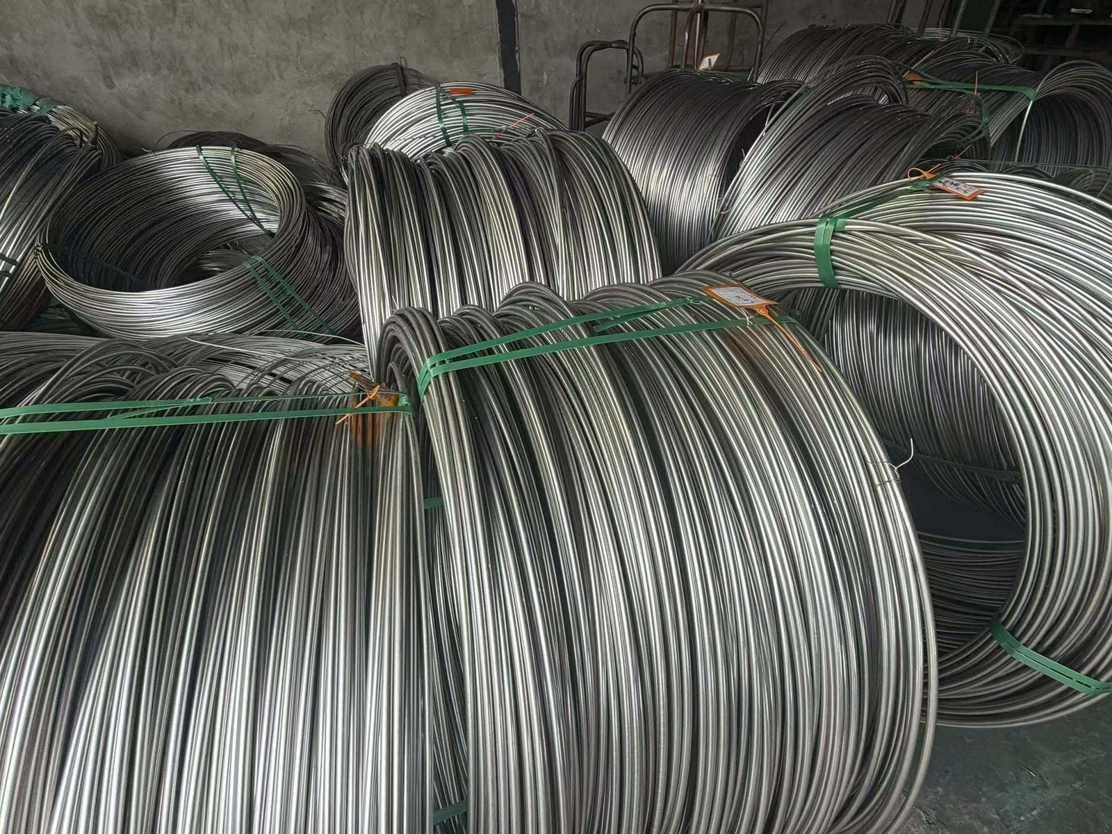 A 40ft shipping container being loaded with coils of wire at a factory