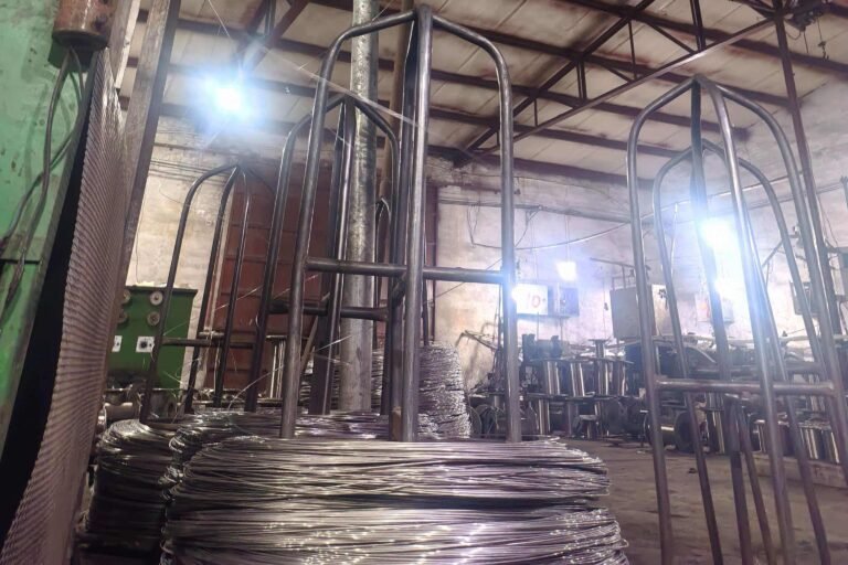 stainless steel wire rod raw material end entering first drawing die at factory production line