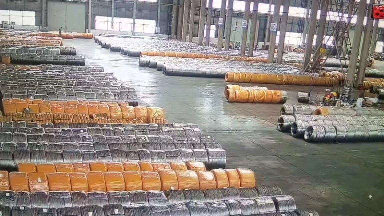 galvanized iron wire coils stored in factory warehouse organized by diameter and coating specification